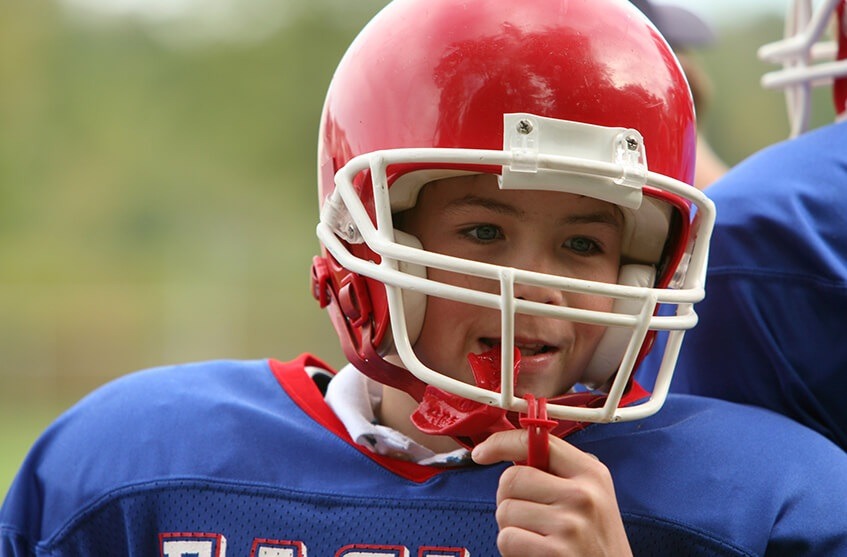 young boy in a football uniform