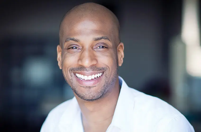 smiling man with bright, white teeth