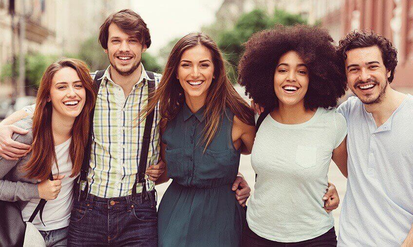 happy group of five young, multi-racial friends