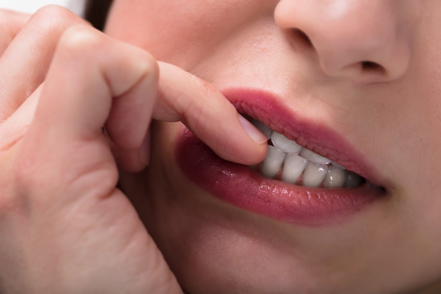 Close up of a women biting her nails